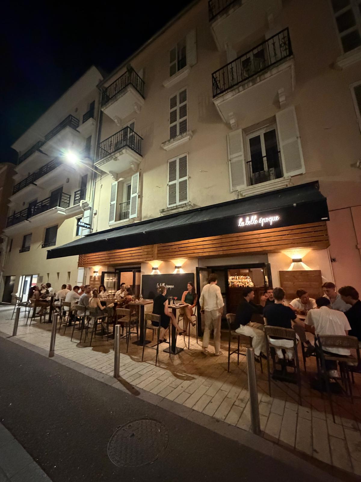 Façade et terrasse de La Belle Époque, rue des Frères Pradignac à Cannes, un soir d’été